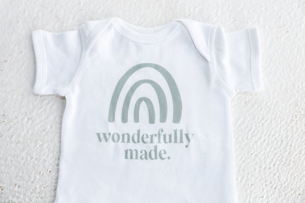onesie with rainbow and says wonderfully made