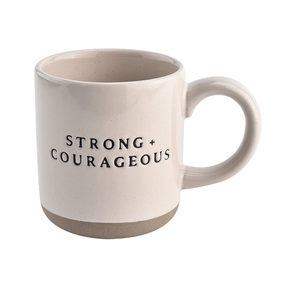 White mug with 'STRONG + COURAGEOUS' text on a white background