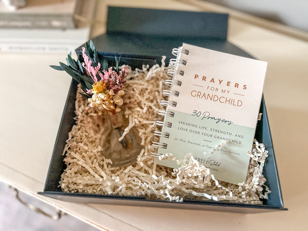 Notebook titled 'Prayers for My Grandchild' in a decorative box with floral elements.